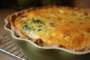 fluffy quiche in a scalloped baking dish